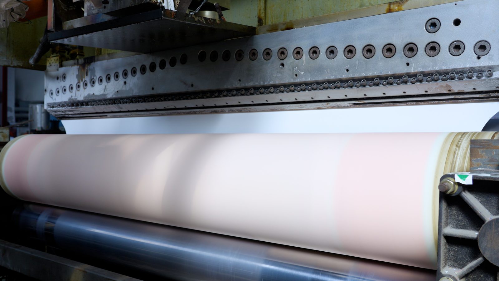 Continuous master roll of solid PEVA plastic tablecloth film on rewinder